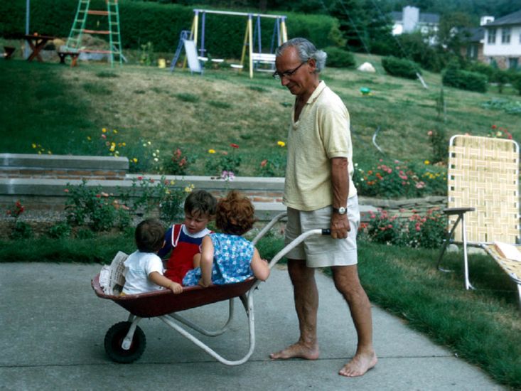  transporting all his grandchildren in wheelbarow